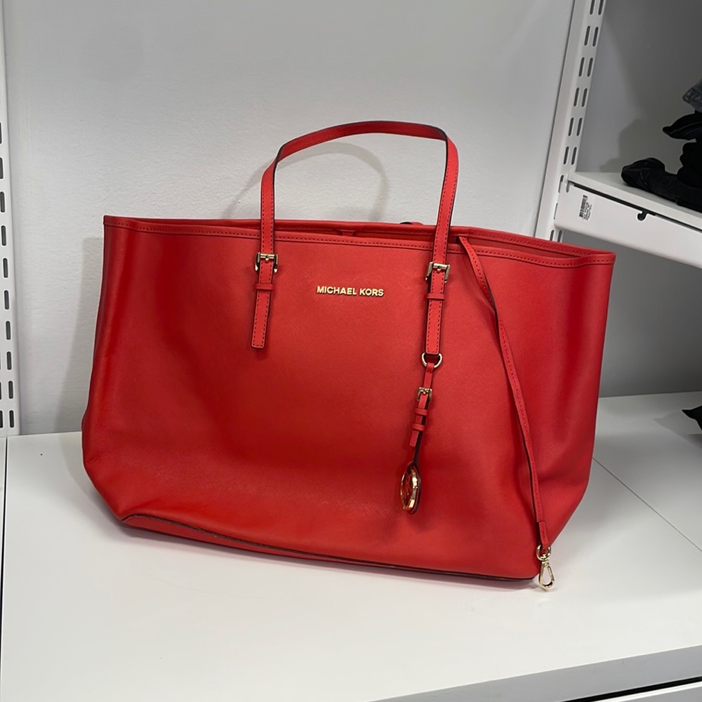 Michael Kors red shoulder bag.